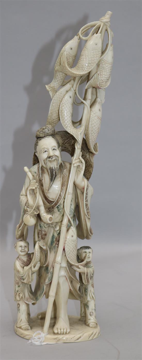 A large Chinese ivory group of a fisherman and two children, first half 20th century, 30.5cm